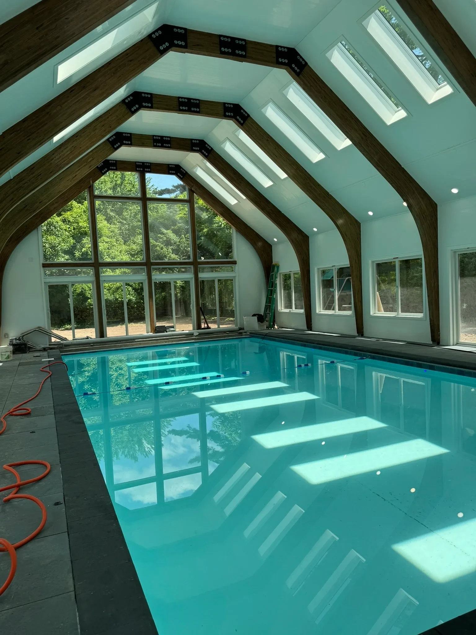Indoor pool with vaulted ceiling and skylights