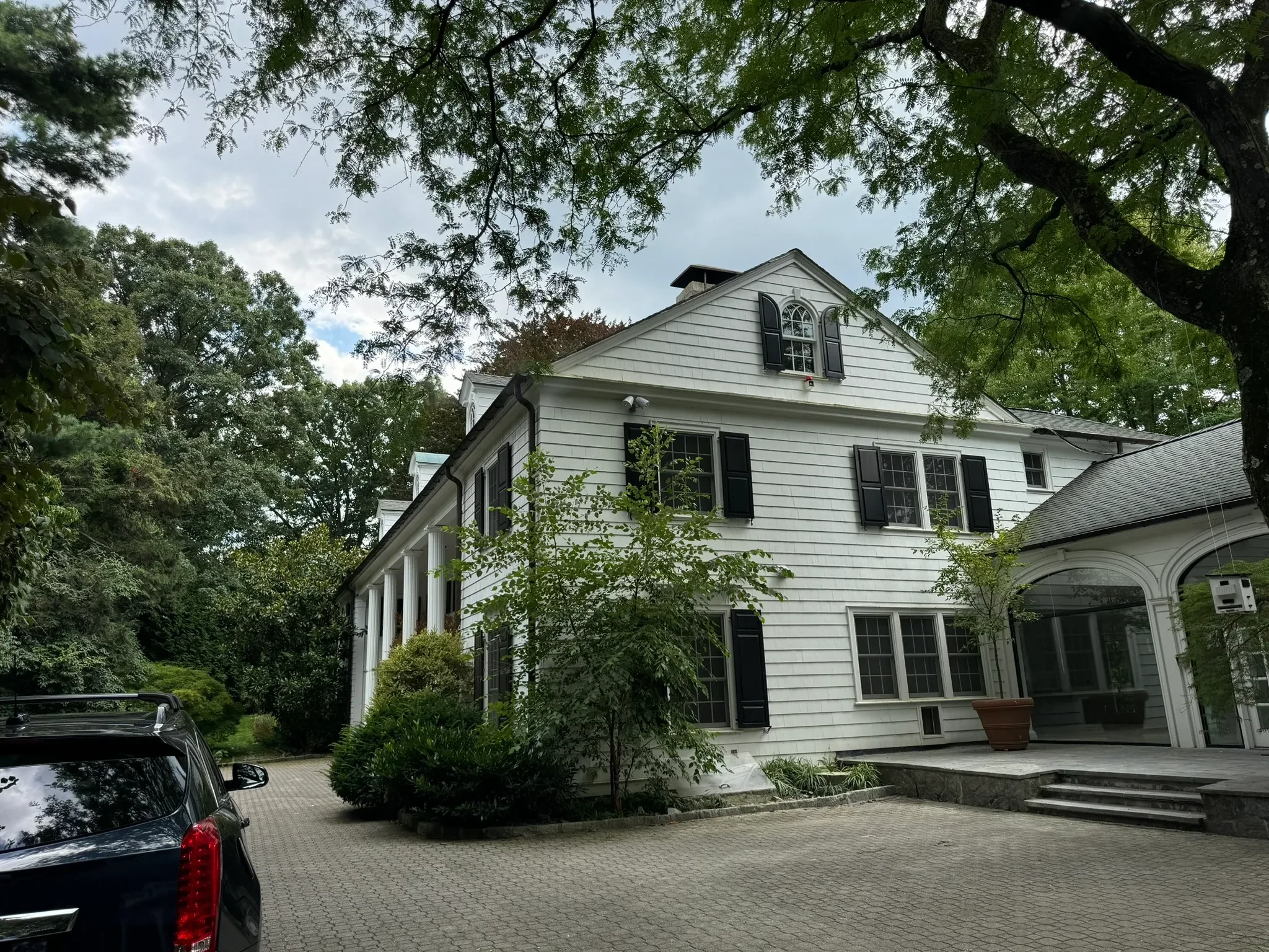 White colonial home exterior with black shutters