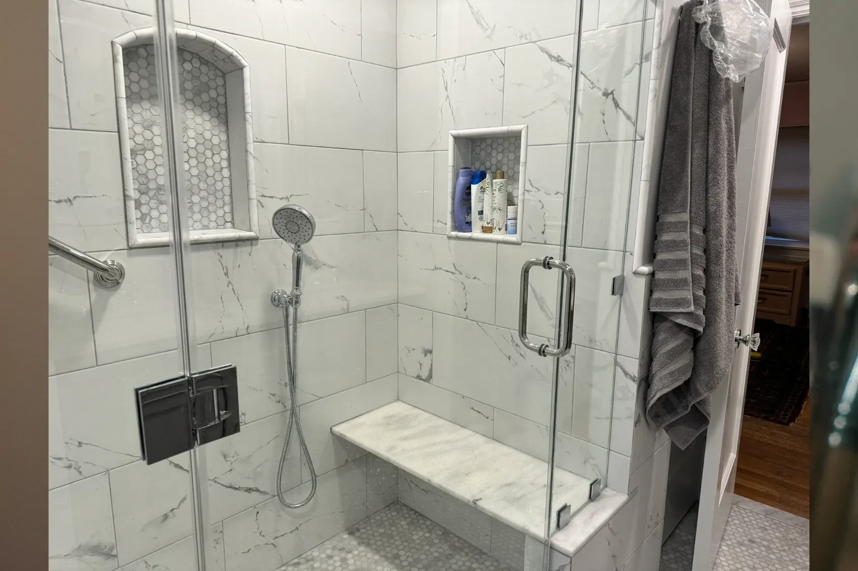 Marble tile shower with built-in shelving