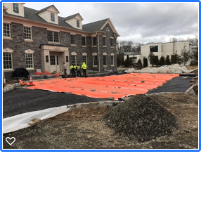 Site work and hardscaping project with stone retaining wall
